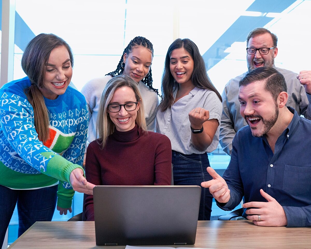Group of people cheering at computer