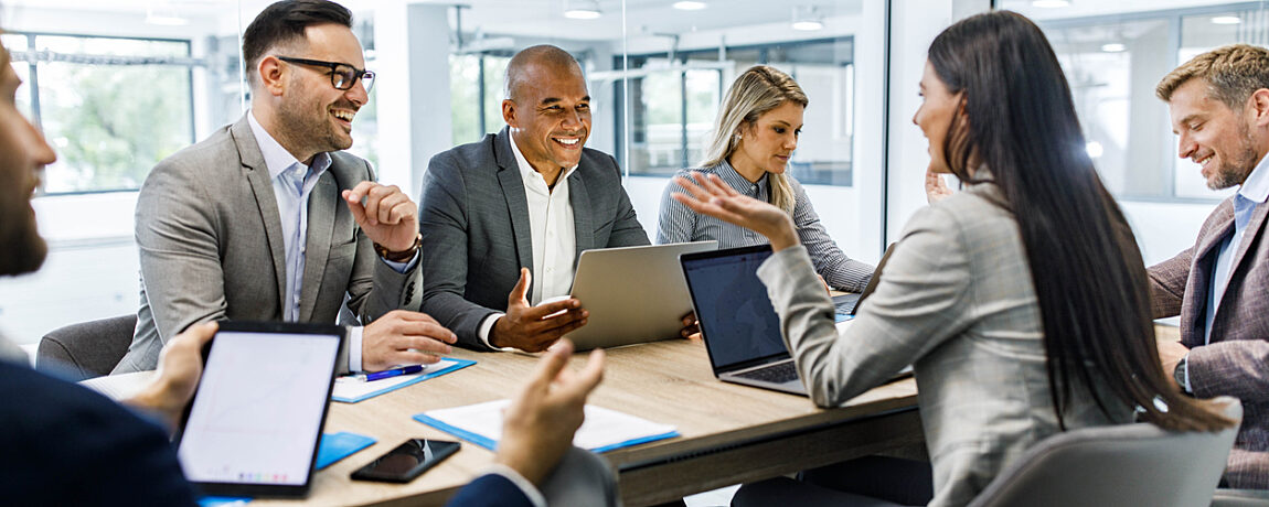 Business people in a meeting, around a table.