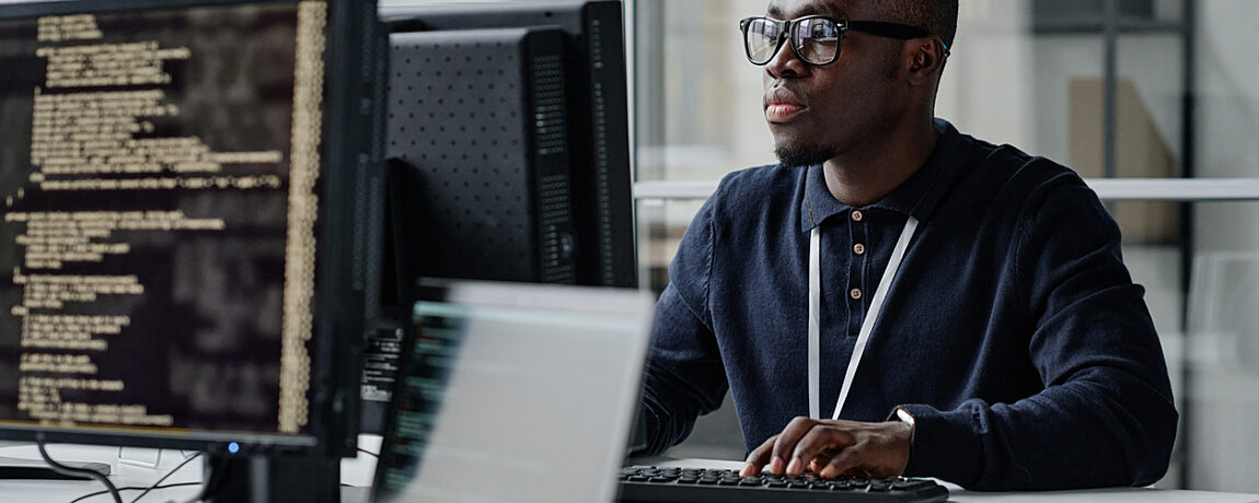 A computer programmer in front of his computer.