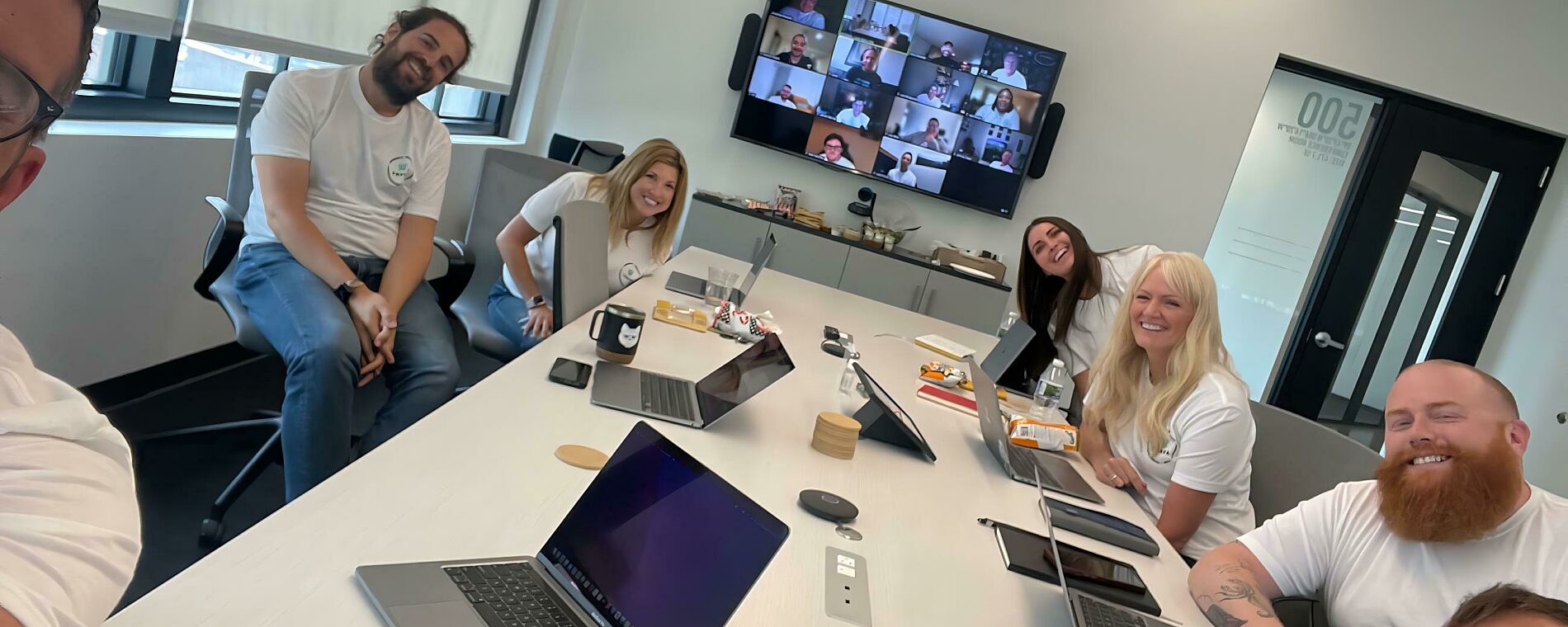 Trava employees posing for a picture around a table!