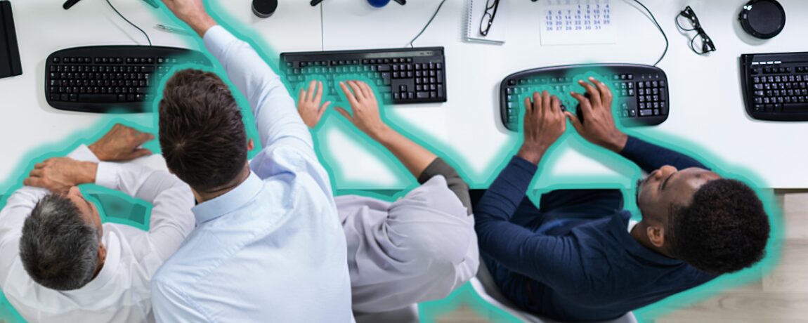 Overhead view of a team working on their computers.