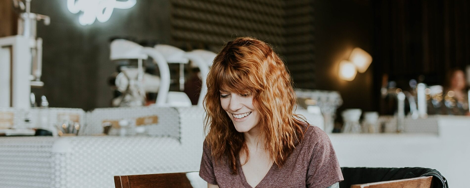 Woman smiling and using her laptop.