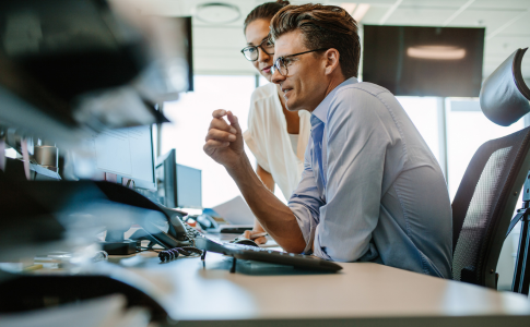 two people looking at computer