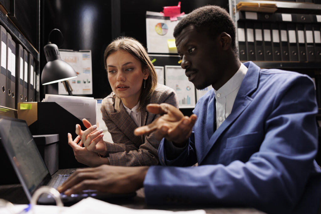 Two people working together at a laptop.